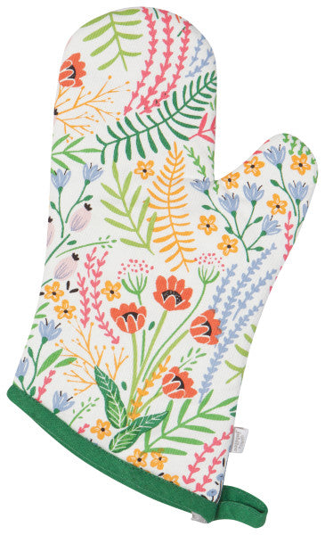 off-white oven mitt with all-over pattern of colorful f lowers and greenery and bright green trim at the opening with a hanging loop.