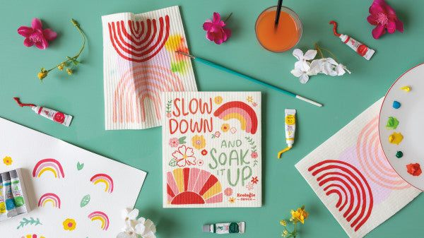 swedish dishcloths surrounded with art supplies.