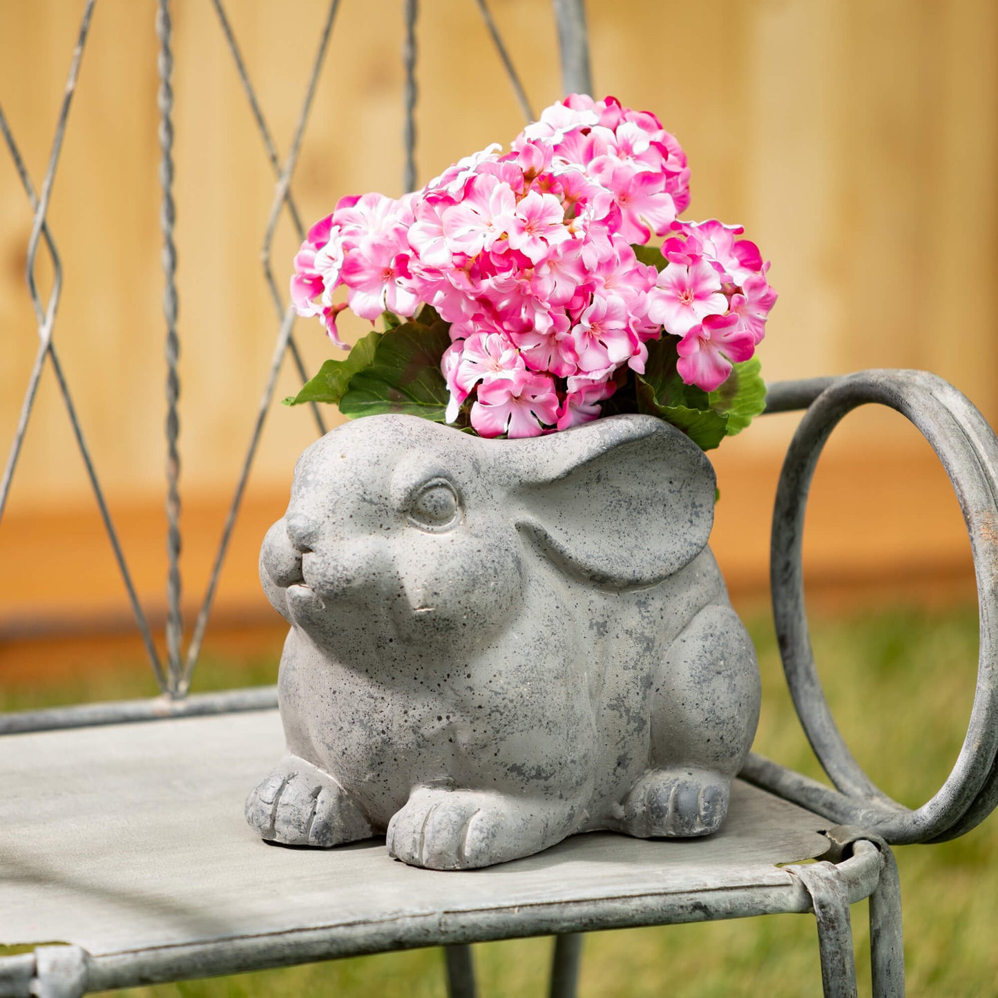 bunny planter filled with pink flowers.