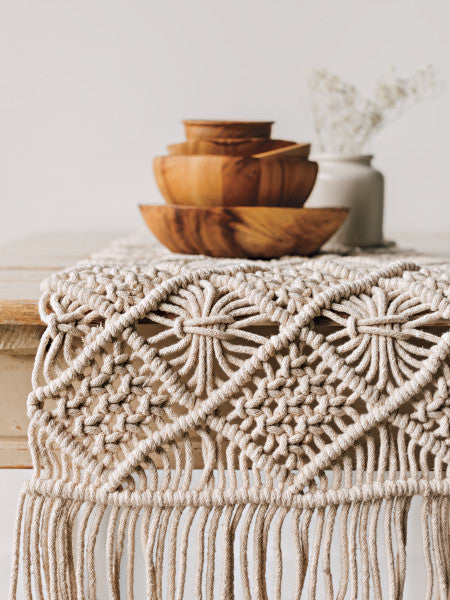 close-up of table runner on table with bowls and vase.