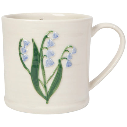 white mug with an embossed sprig of bluebell on it