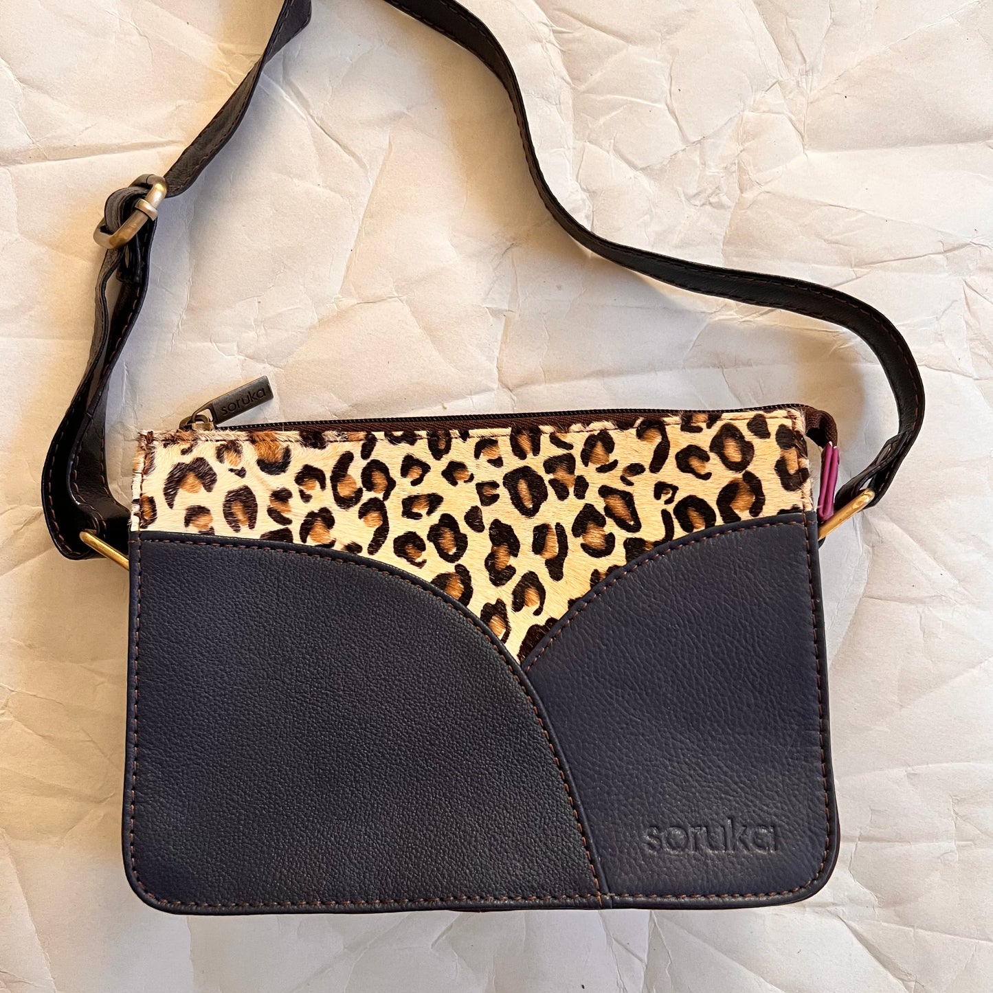 front of navy meredith purse with cheetah print and blues.