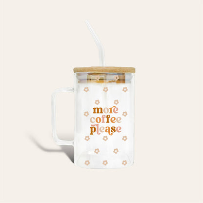 clear glass mug with "more coffee please" printed in the center surrounded by small pink daisies on a light pink background.