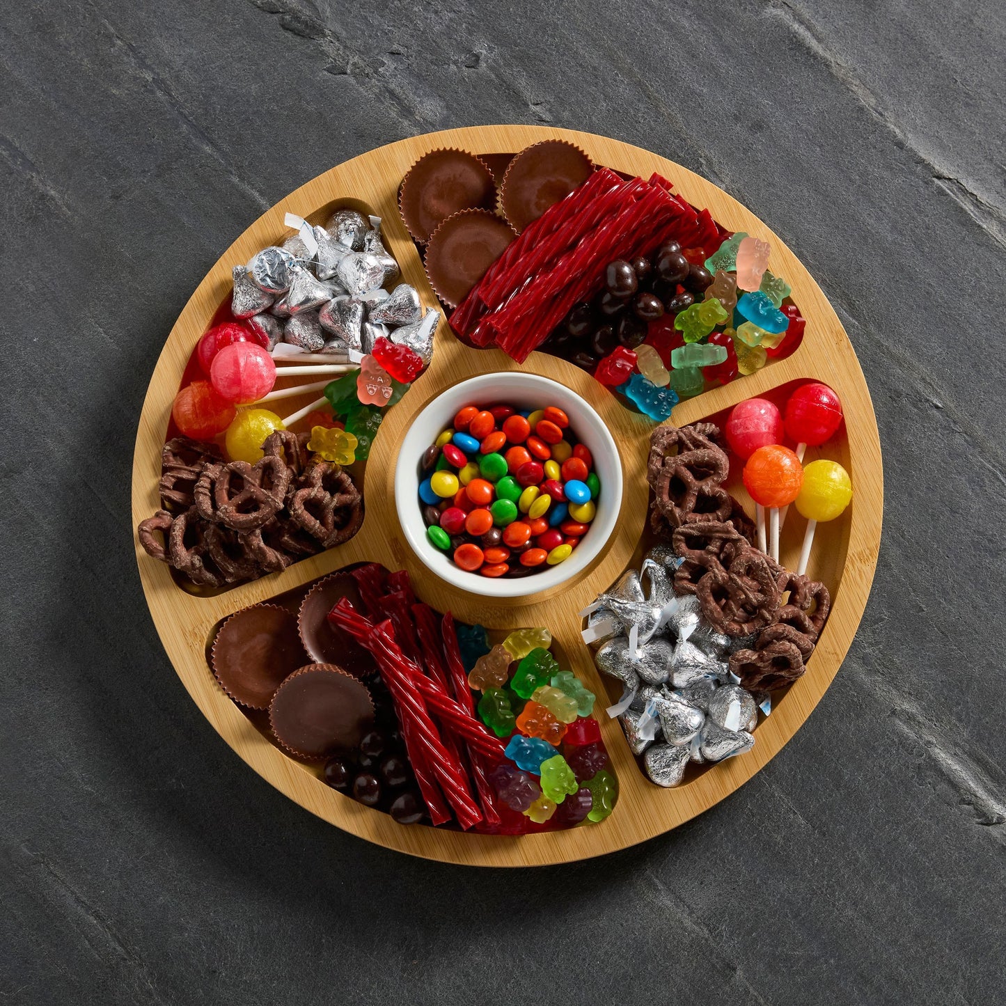 Top view of round builder board filled with assorted candies.