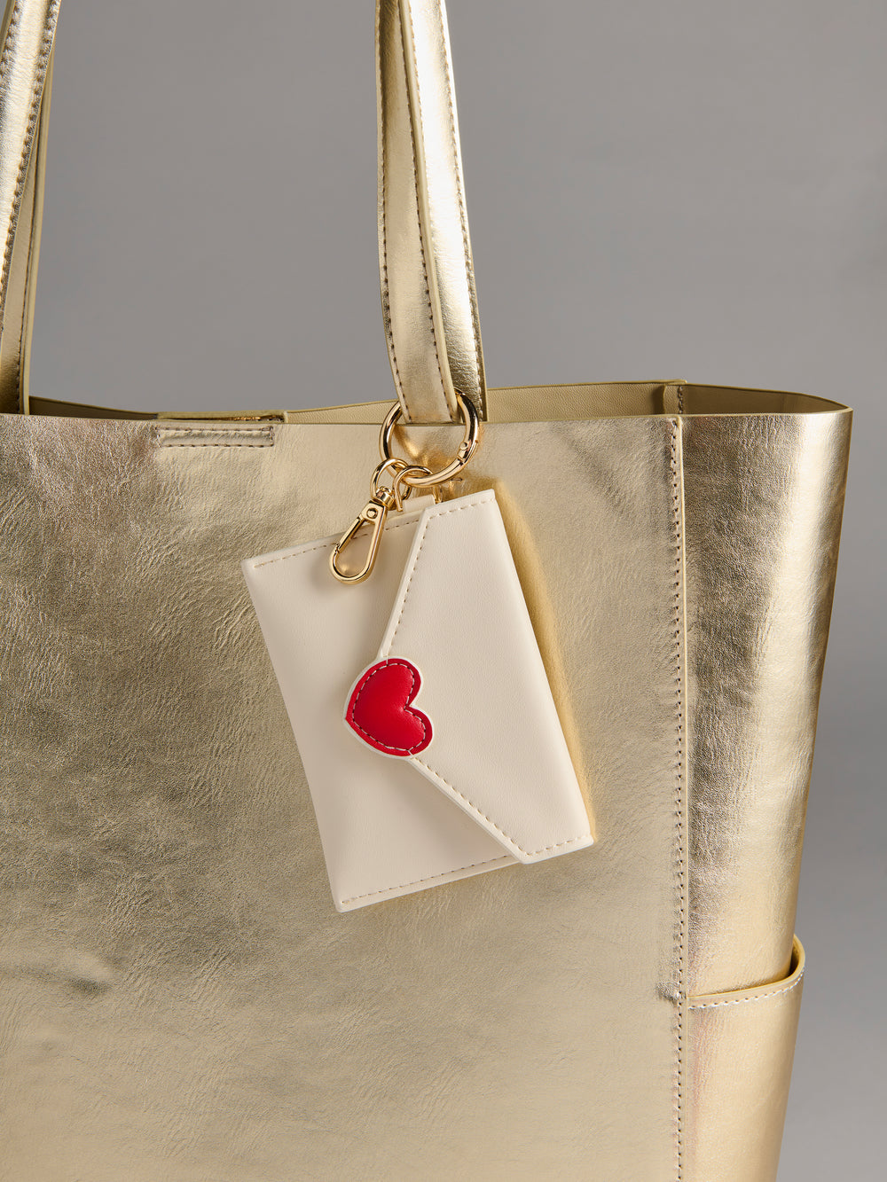 ivory Love Letter Card Case on a gold bag