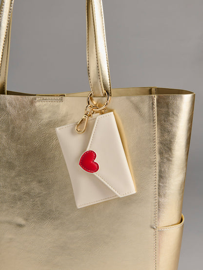 ivory Love Letter Card Case on a gold bag