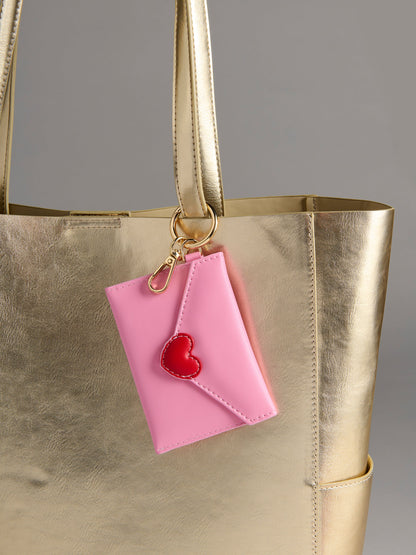 pink Love Letter Card Case on a gold bag