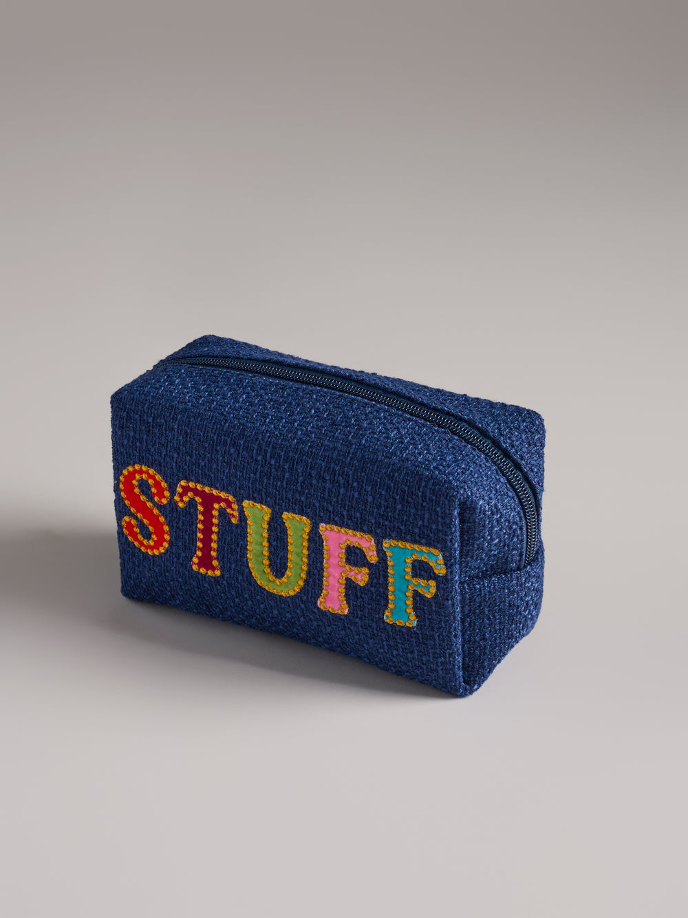 navy bag with multi colored text of the word "stuff"