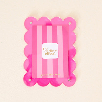 Scalloped hot pink magnetic frame against a white background.