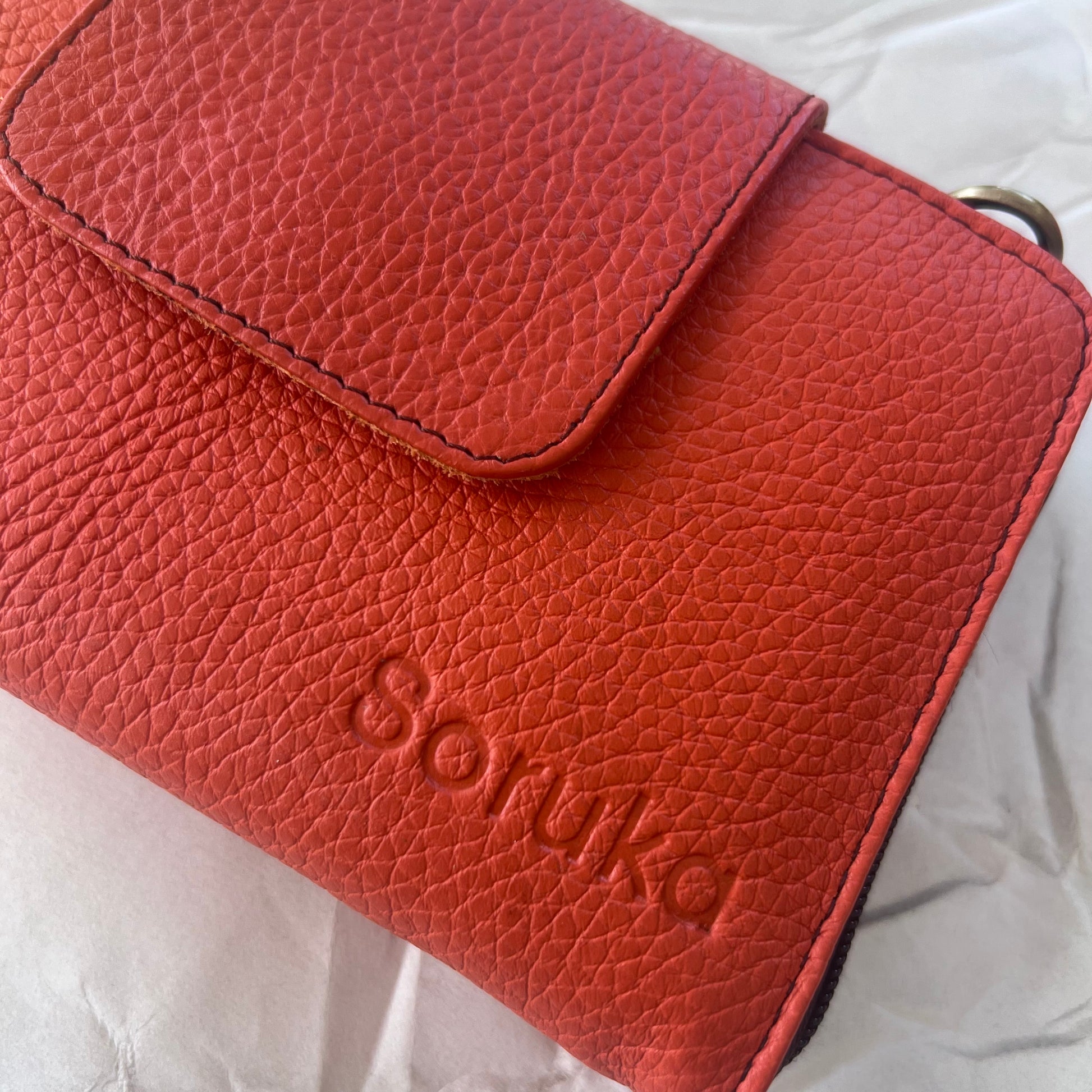 close-up of orange Beatrice Clutch