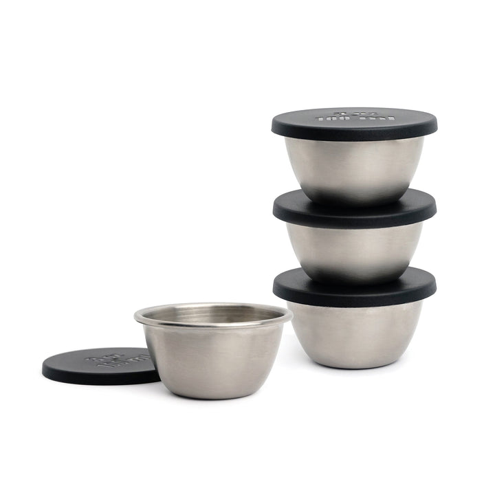 3 small stainless steel bowl stacked and another bowl set next to them