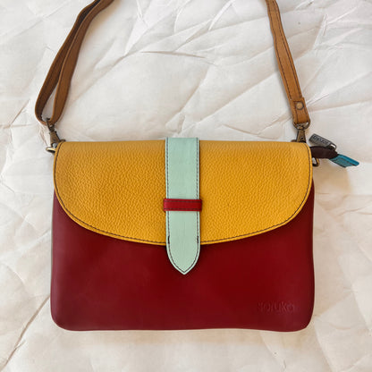 saddle bag with crossbody strap attached.