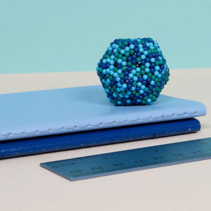 geometric shape made from Gigabyte speks set on a stack of books