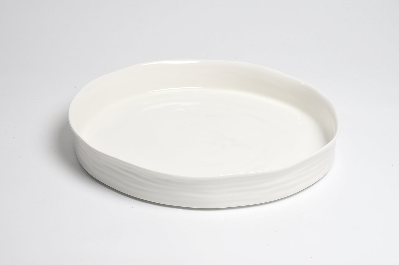 white round serving platter with straight, shallow sides