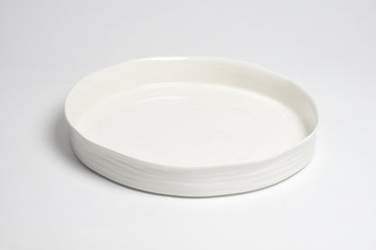 white round serving platter with straight, shallow sides