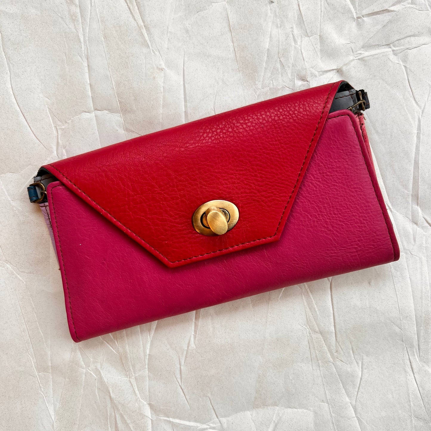 front of berry secret clutch wallet with red flap.