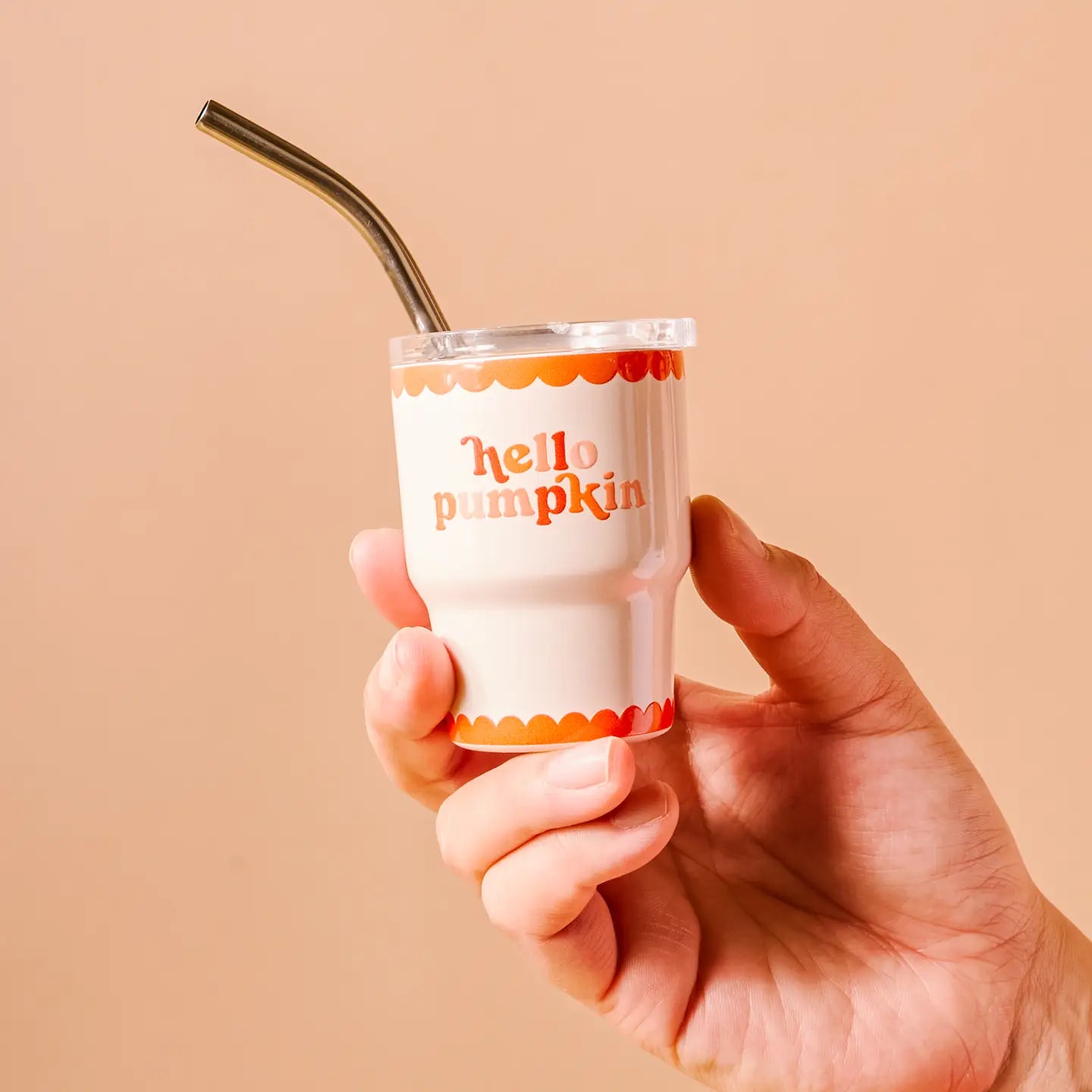hand holding Hello Pumpkin tiny tumbler