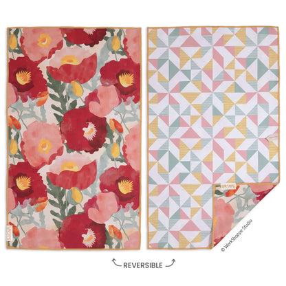 reversible towel with red florals on one side and a geometric pattern on the other