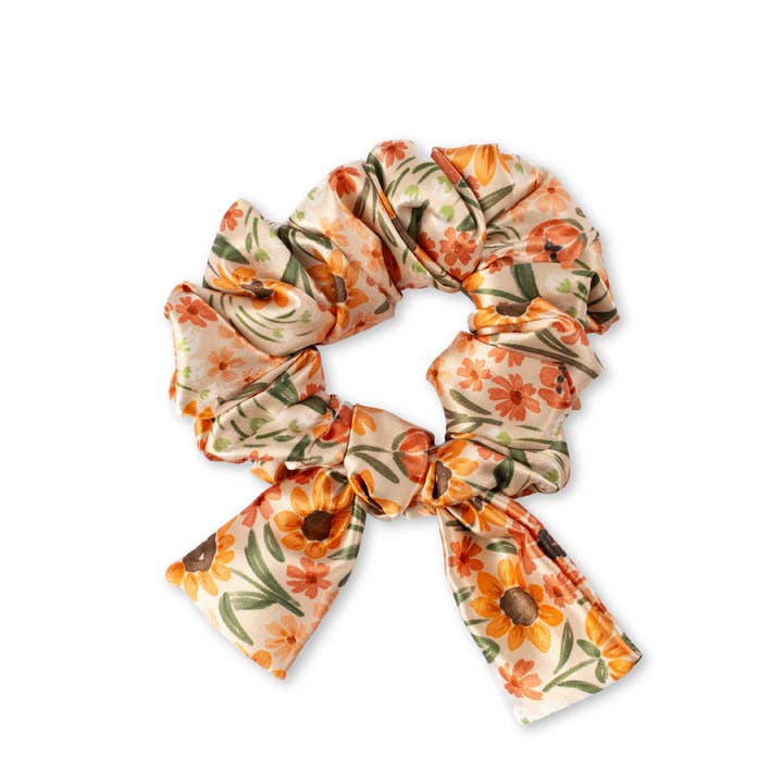 pale orange scrunchie with floral design in peachy orange hues