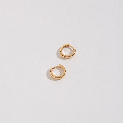 Small Huggie Hoops on a white background.