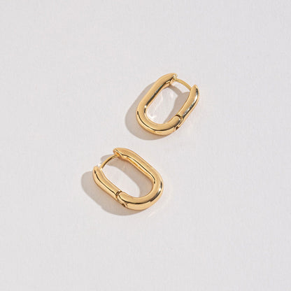 gold medium link huggie hoops on a white background.