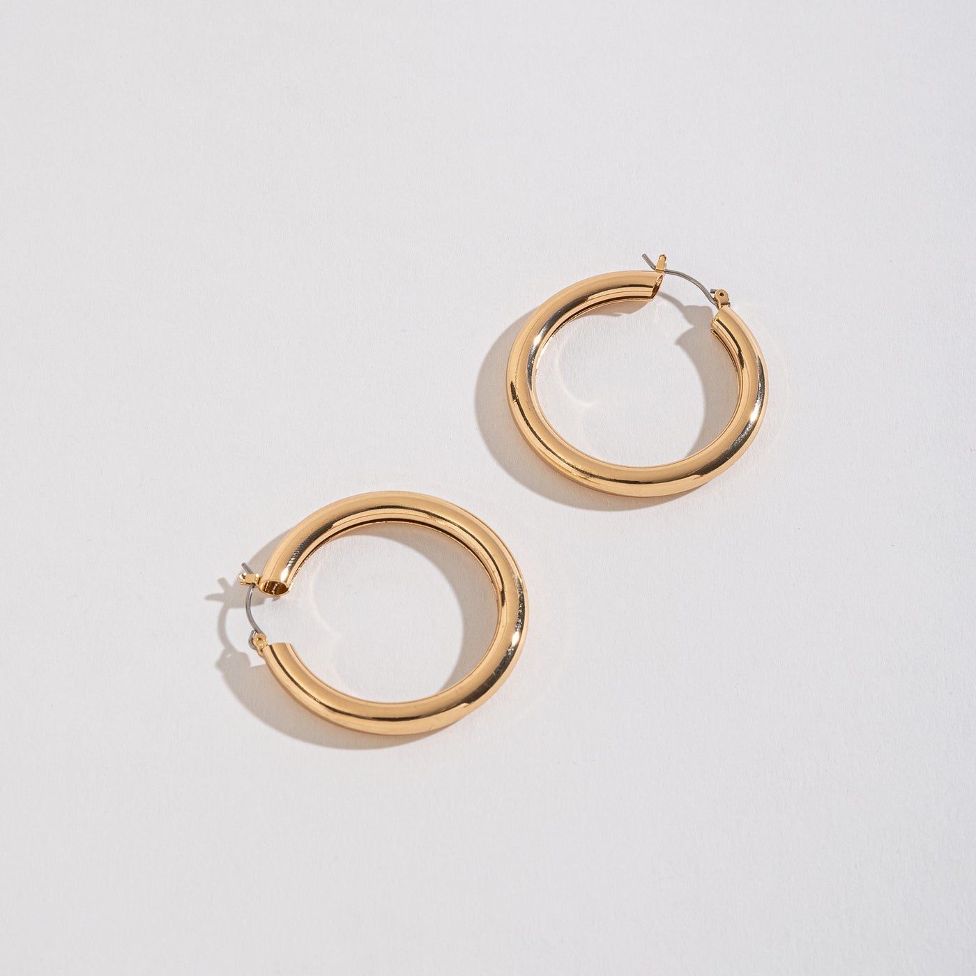 gold tube hoops on a white background.