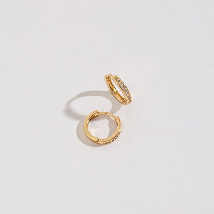 gold small pave huggie hoops on a white background.
