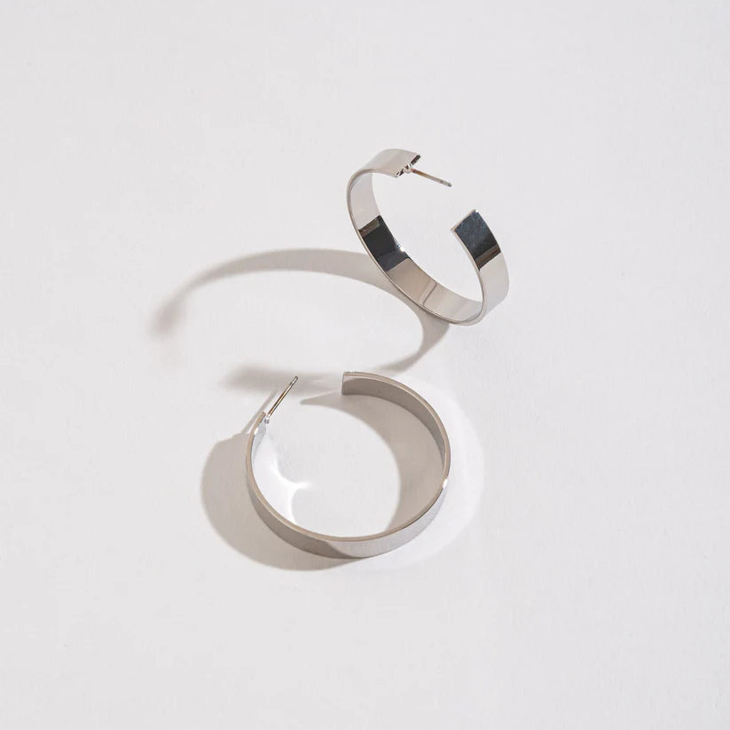 Large Flat Hoop Earrings on a white background.