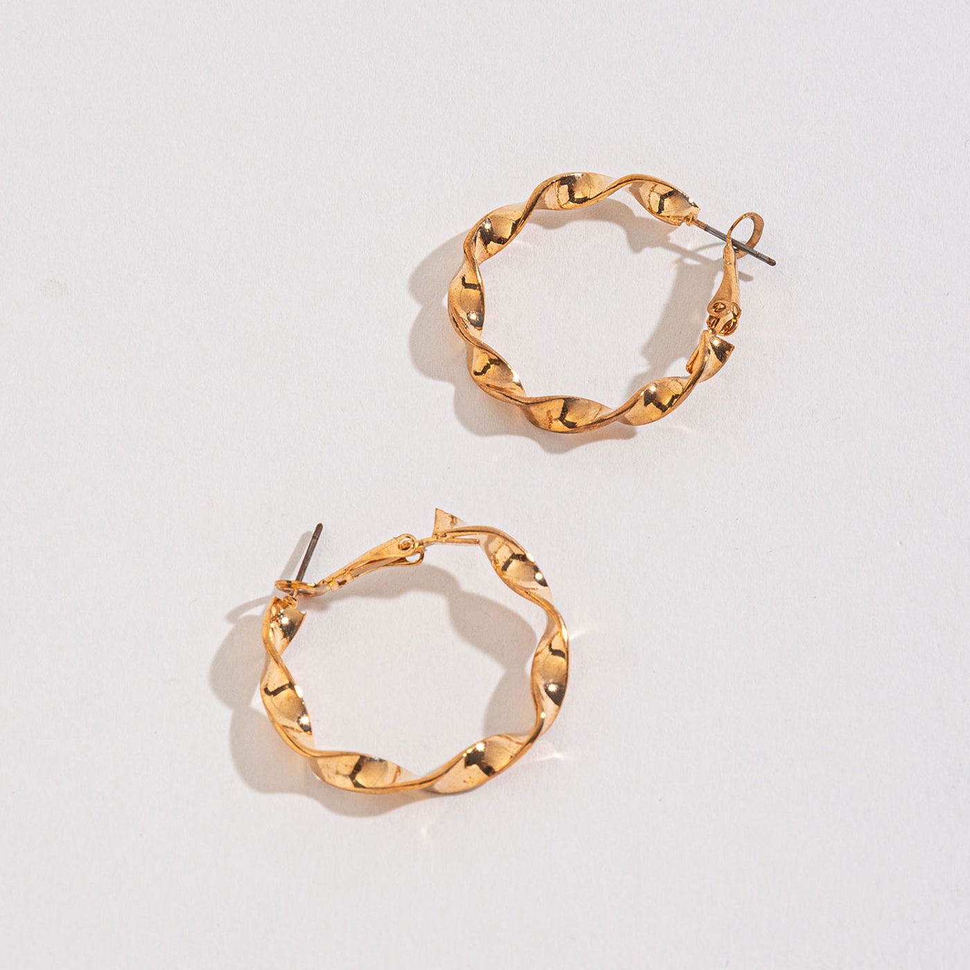 gold twist hoops on a white background.