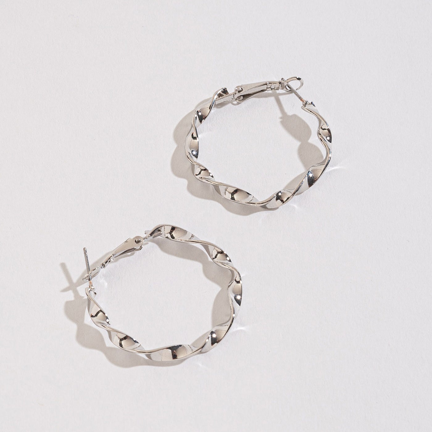 silver twist hoops on a white background.