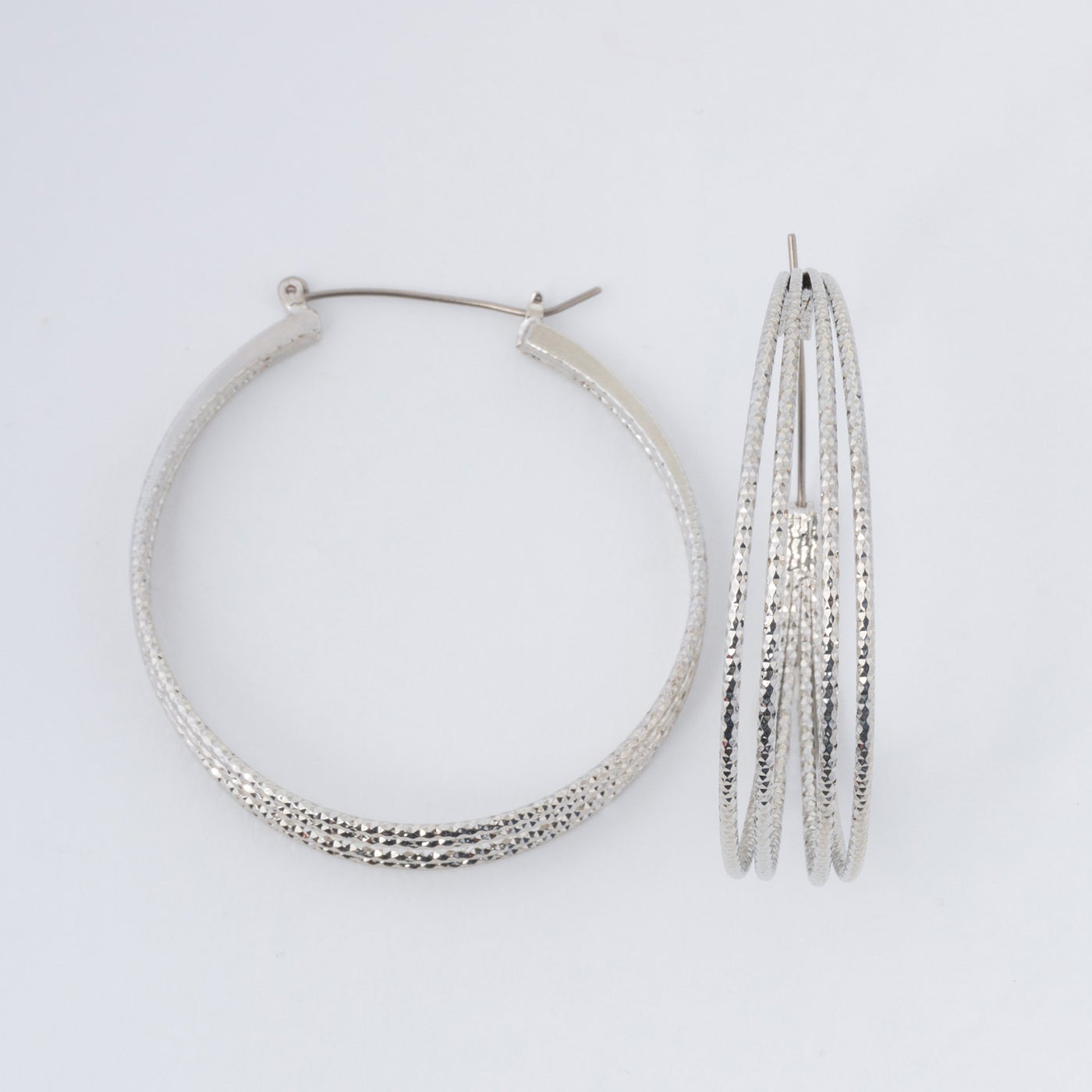 silver sparkle hoops on a white background.