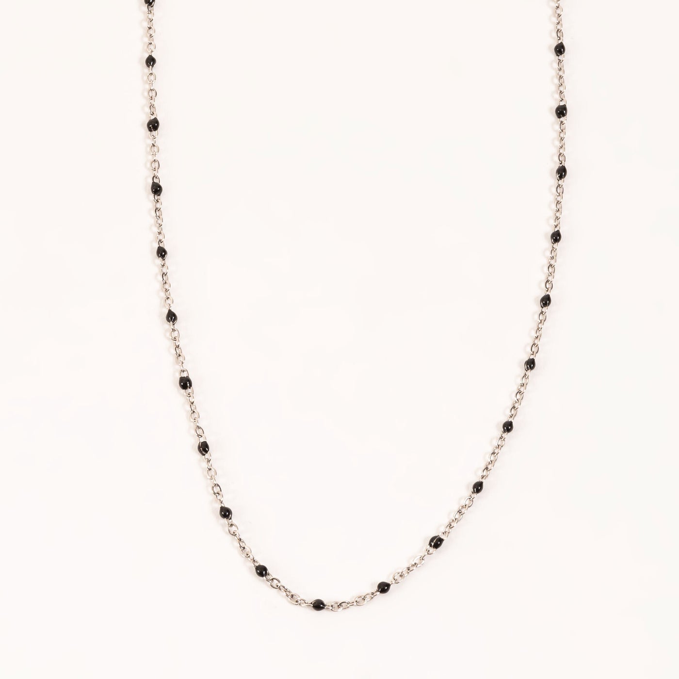 silver chain with black bead along it.