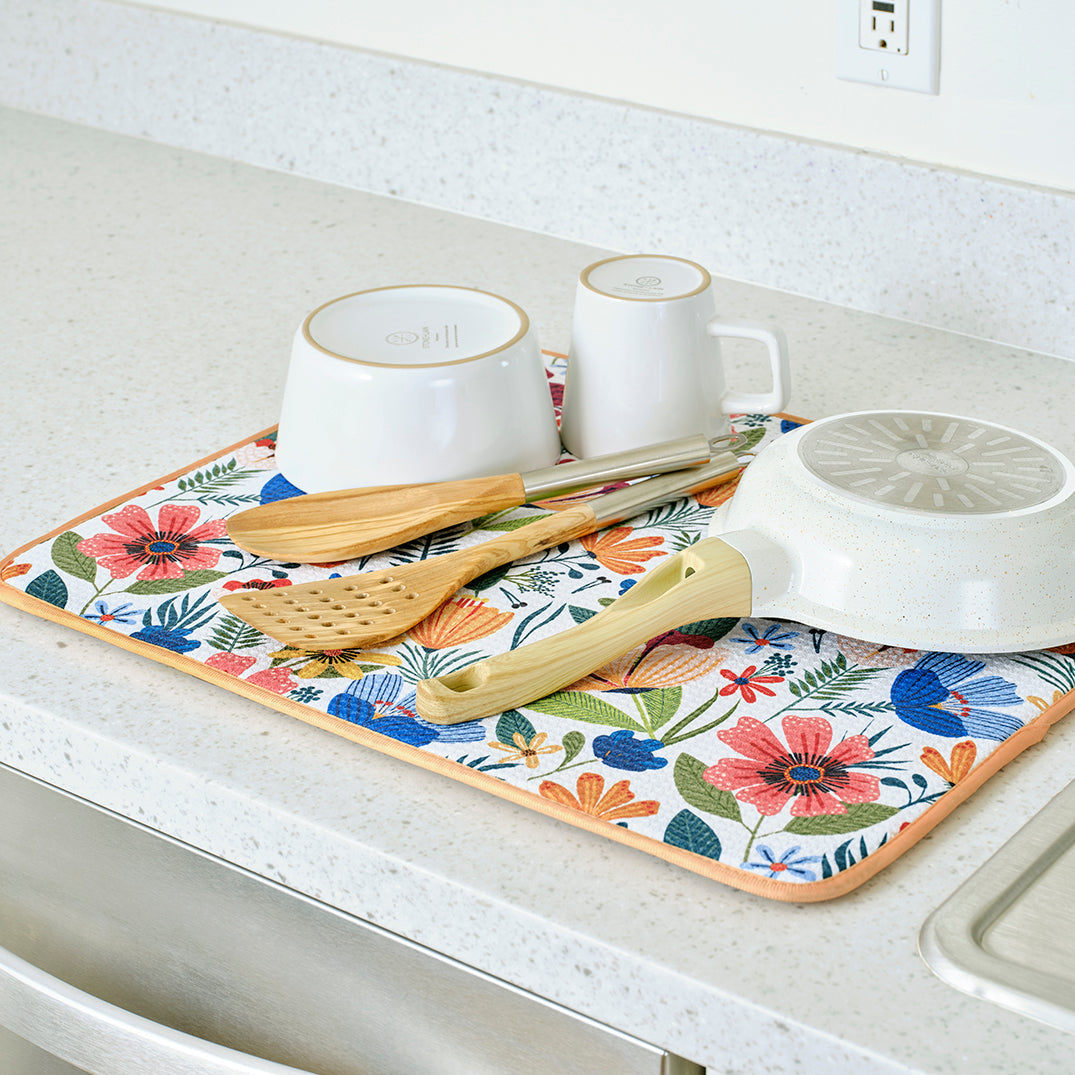 1 field of flowers dish mat with kitchen items drying on it