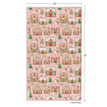 Pink towel with gingerbread house pattern and measurements on a white background