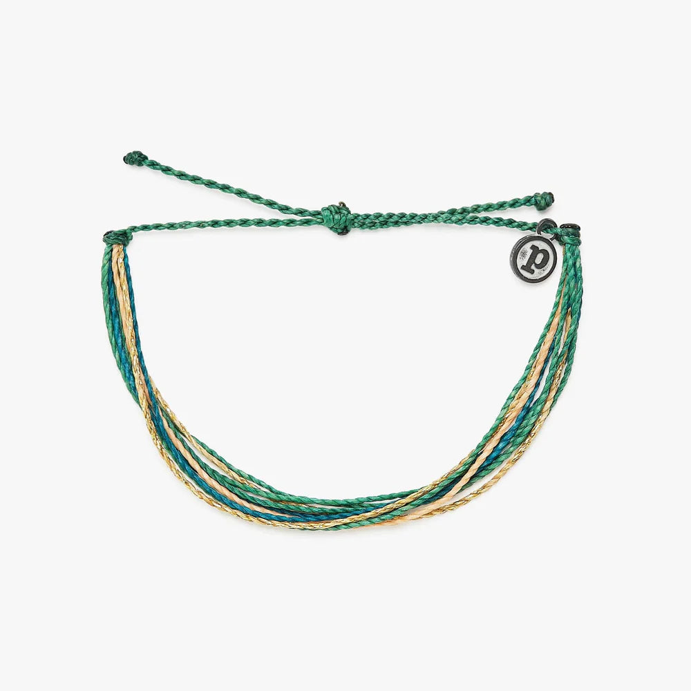 Pura Vida multi strand corded bracelet in varying shades of teal, green, and gold with a Pura Vida logo charm
