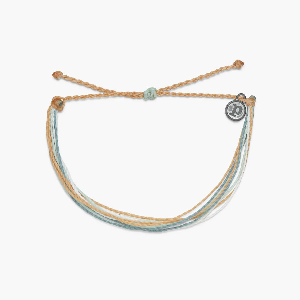 Pura Vida multi strand corded bracelet in varying shades of tan, white, and dusty blue with a Pura Vida logo charm