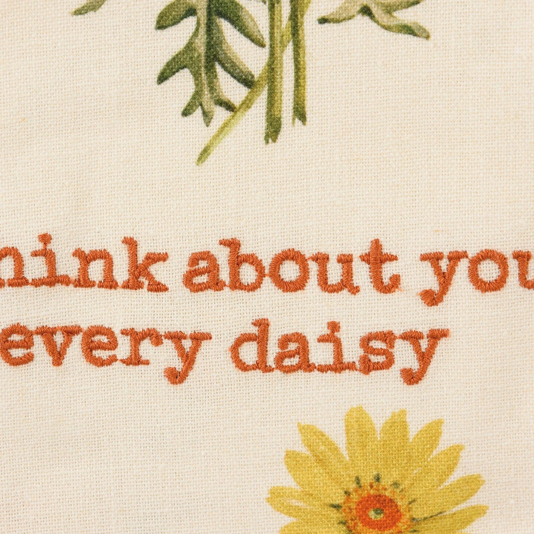 close-up of "I think about you every daisy" embroidery on towel