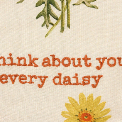 close-up of "I think about you every daisy" embroidery on towel