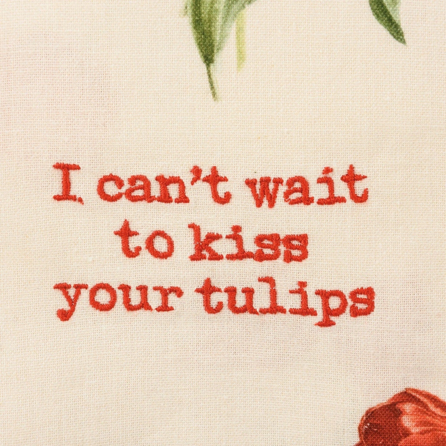 Close up of "I can't wait to kiss your tulips" embroidery on a towel
