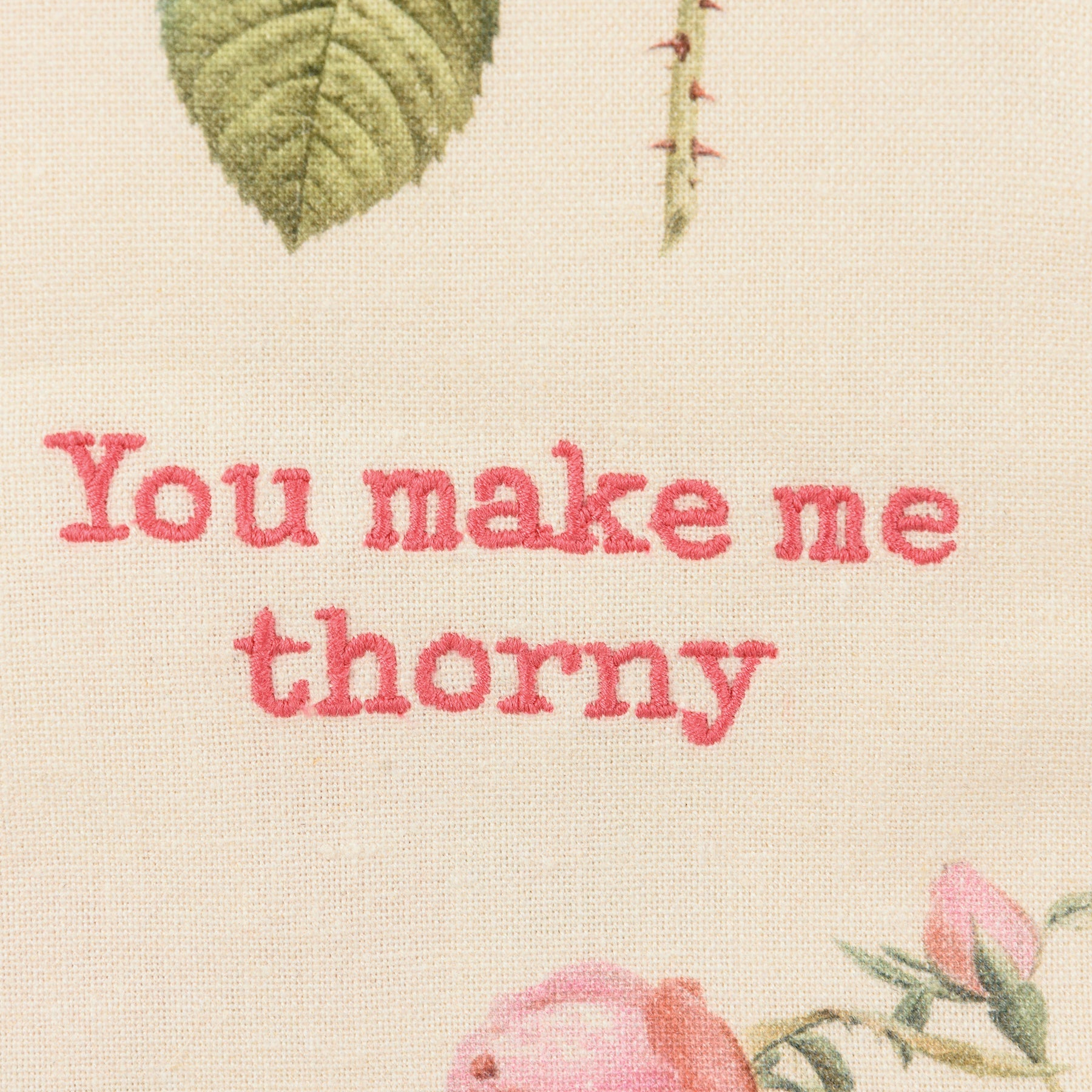 close-up of embroidery on You Make Me Thorny Dishtowel