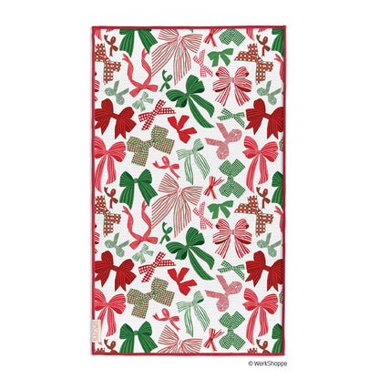 white towel with all-over design of assorted red and green bows