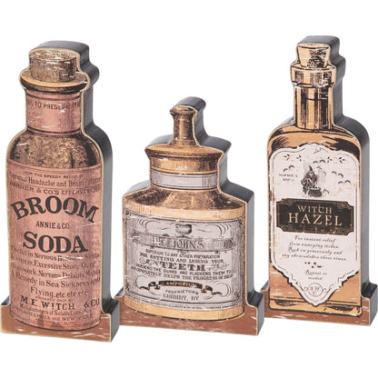 three decorative wooden bottles with vintage labels on a white background