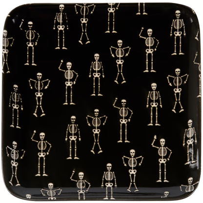 A square black plate with rounded corners, featuring a repeating pattern of small skeleton figures in various poses.