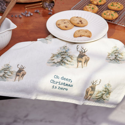 oh deer towel draped on a table with plates of cookies.