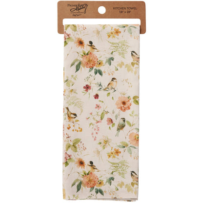 Floral and bird patterned kitchen towel on a white background