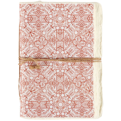 red patterned note book tied with jute