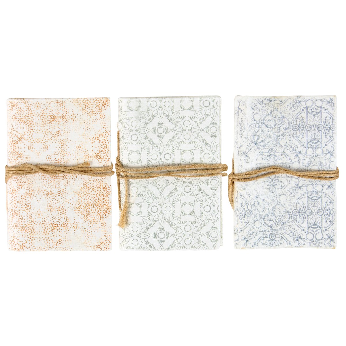 Three patterned notebooks tied with twine in a row on a white background