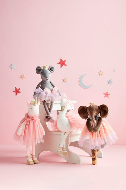 four plush princess toys on a pink background