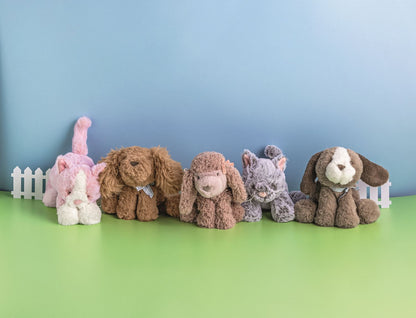 plush kittens and puppies in a decorated setting