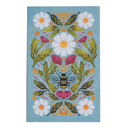 blue notebook with floral and bee design.